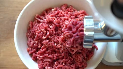 Minced Meat in a Meat Grinder Preparing Fresh Ground Beef for Cutlets in the Kitchen