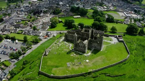 Orbiting drone shot of Rock of Cashel overlooking Ireland's countryside.