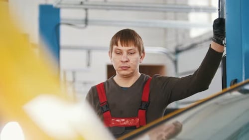 Car in Auto Service Lifting for Repairing Mechanics in Garage