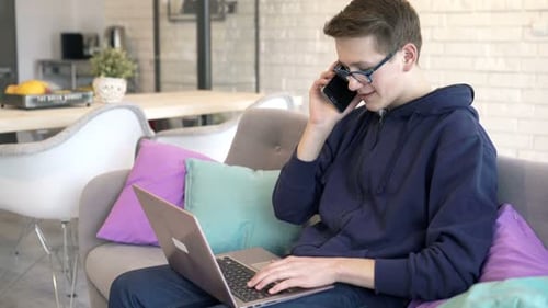 Teen using laptop computer while talking on phone