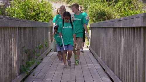 Group Of Volunteers Cleaning Up Park