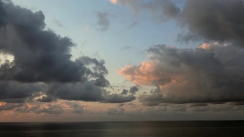 Dark storm clouds approaching over open sea creating dramatic and tense marine atmosphere.