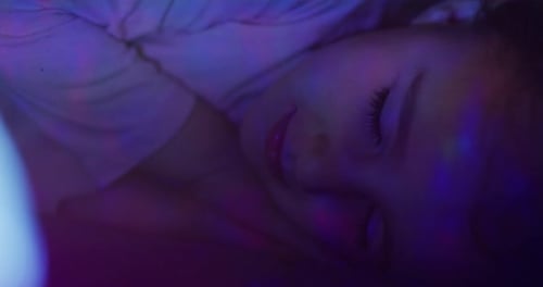 Young Child Sleeping Peacefully in Dark Bedroom