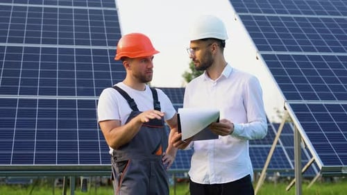 Two Engineers Boss and Subordinate are Conducting Outdoor Inspection of Solar Photovoltaic Panels