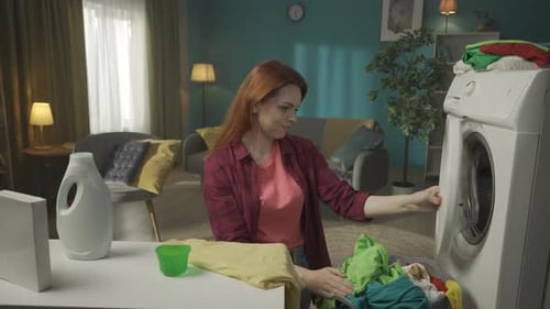 Woman Doing Laundry at Home in Living Room