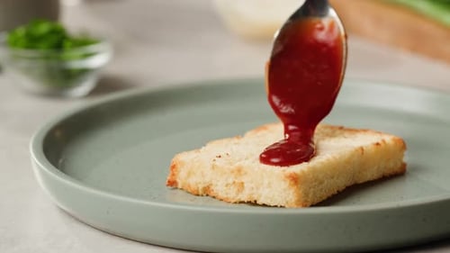 Adding Red Sauce Jam on Fried Bread Closeup Cooking Sandwich at Cafe Pouring Tomato Sauce on Top