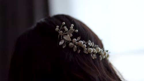 A beautifully captured close-up image showcasing an elegantly dressed bride wearing a headband.