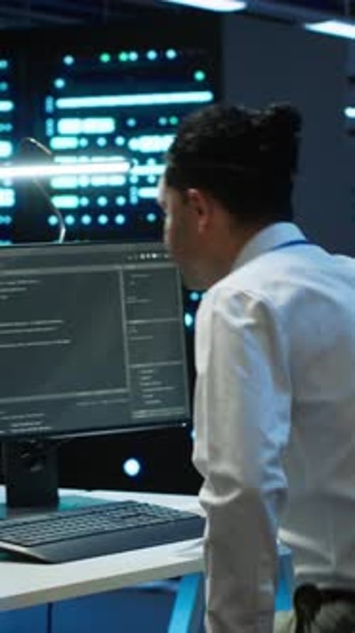 Vertical Video IT Professional in Server Hub Establishing Performance Benchmarks