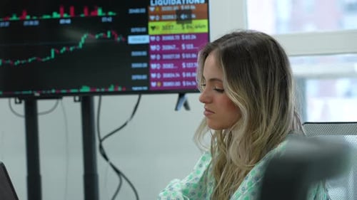 Woman Working with Stock Market Data in Office