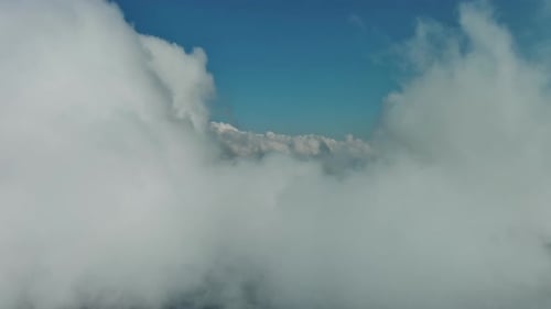 Clouds and Mountains Flying in Clouds