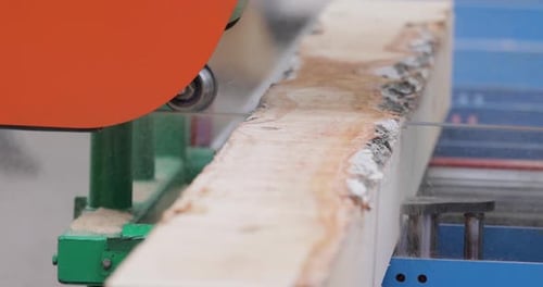 Work of the sawmill in close-up. Process of machining logs in equipment sawmill machine saw saws the