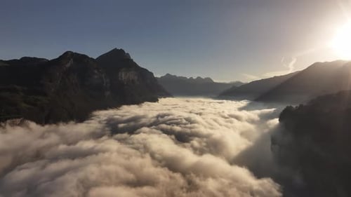 Drone flight near the clouds over Walensee Lake, in the region of Amden, Switzerland.
