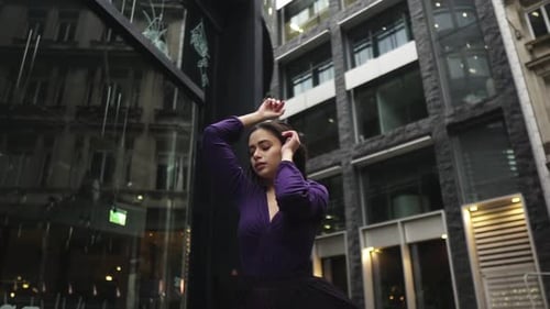 Woman Poses in Purple Dress in Urban Setting