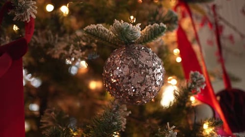 Sparkling Christmas Ball Ornament on Festive Decorated Tree