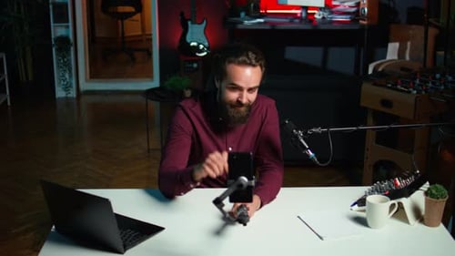 Man Using Phone Camera and Professional Microphone to Record