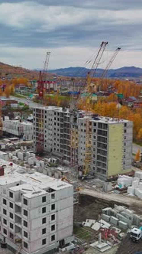 Construction Progresses on Apartment Buildings in a Developing Neighborhood Surrounded By Autumn