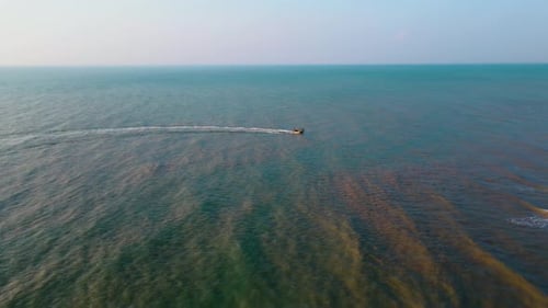 Drone Footage of a Boat Leaving a Trail on the Ocean Surface