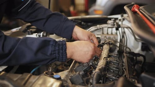 People Occupation and Business Job Automobile Mechanic Repairman Repairing a Car
