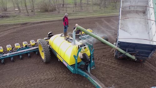 Blue tractor OA working on the field in Ukraine