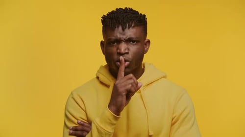 Silence Please Man Gesturing for Quiet on Yellow