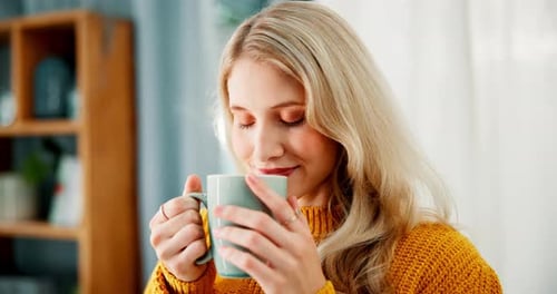 Woman Enjoys Hot Drink at Home