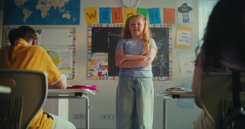 Elementary School Girl Presenting Homework on Ecology in Front of Classmates and Teacher