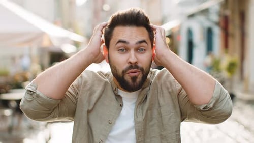 Young Man Looking Surprised at Camera Shocked By Sudden Win Good Victory News Wow in City Street
