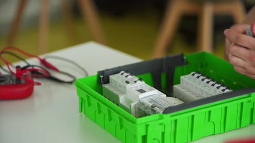 Electrician Assembles Electrical Panel Fuse Box in Workshop Worker Installs Energy Meter Switches