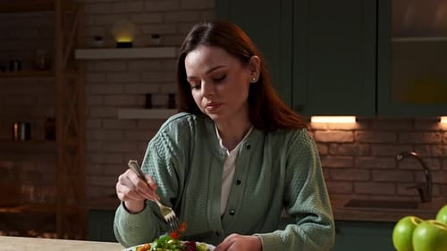 Woman Enjoying Healthy Salad in Cozy Kitchen