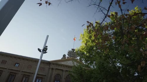 View From Below of a Spanish Flag Flying on an Official Building