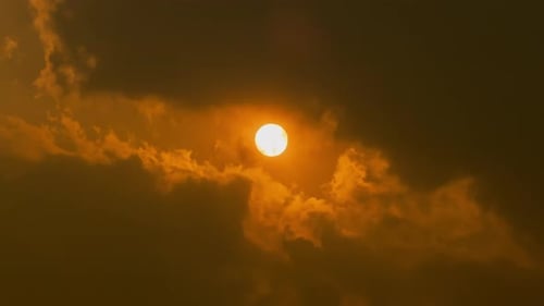 Sun Peeking Through Golden Orange Sky Clouds