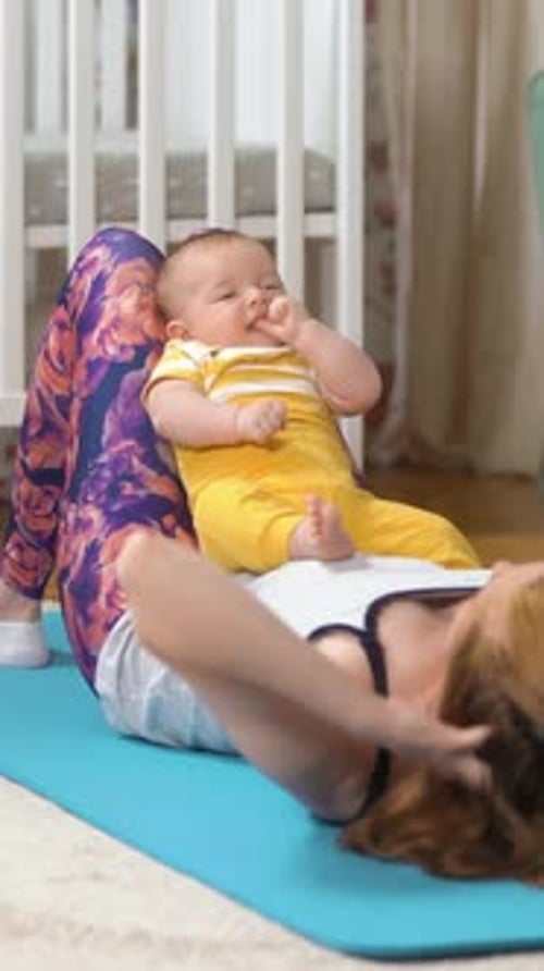 Woman Doing Sit-Ups with Infant on Stomach