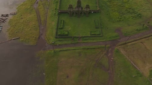 Aerial view of misty Tamblingan Lake with temple, Indonesia.