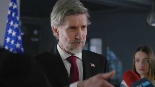 American Official Speaking at a Press Conference