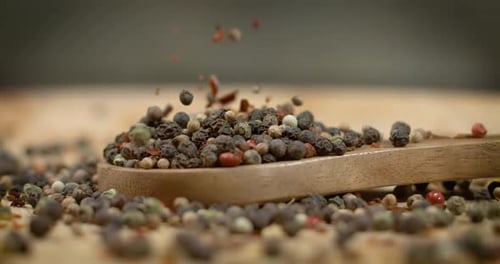 Mixed peppercorns in a super slow motion. Dry mix peppercorns close up.