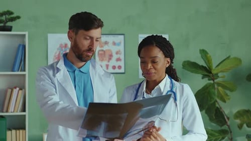 Medical professionals review X-ray image in doctor's office