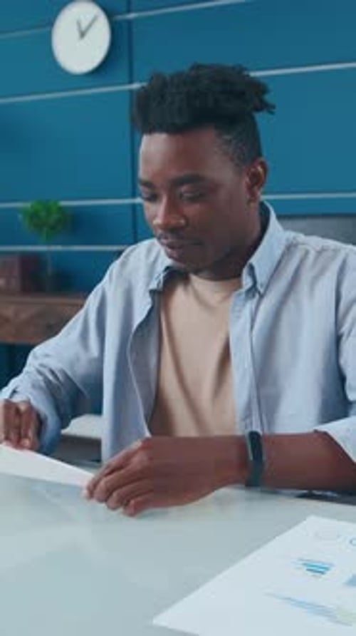 Young Adult Making and Throwing Paper Airplane