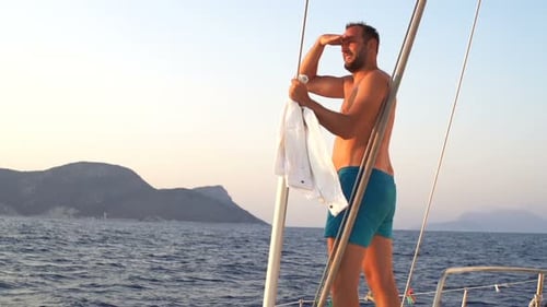 Man with Hand Admire View While Sailing Boat on Sea 30s
