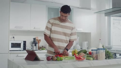 Young Man Preparing Healthy Food in Kitchen
