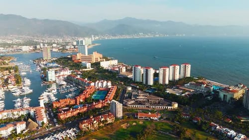 Aerial View Of Puerto Vallarta Cityscape Meeting The Pacific Ocean In A Stunning Sunset. Mexico