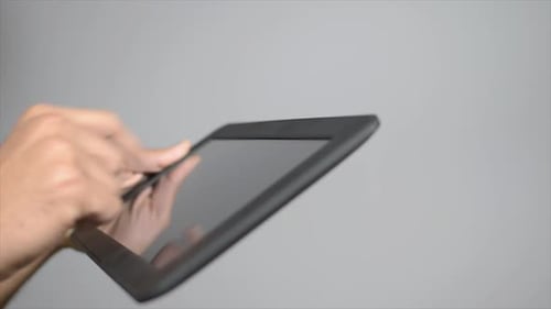 Hands Interacting with Tablet Touchscreen Technology