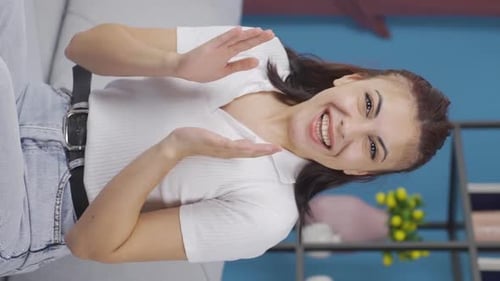 Smiling Woman Clapping and Giving Thumbs Up Indoors