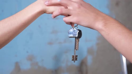 Own Home Mortgage Relocation Concept Couple Hands Holding Key From New First House Family