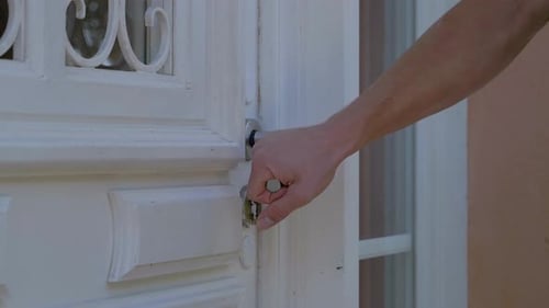Captura a cámara lenta de personas que entran a una casa por una puerta