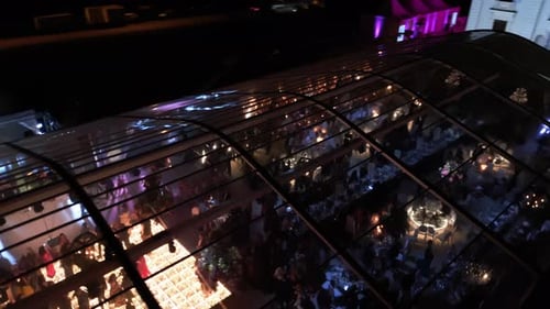 Aerial Shot From Above Colorfull Dance Hall with Lots of Lights Wedding Party Big Crowd at Night