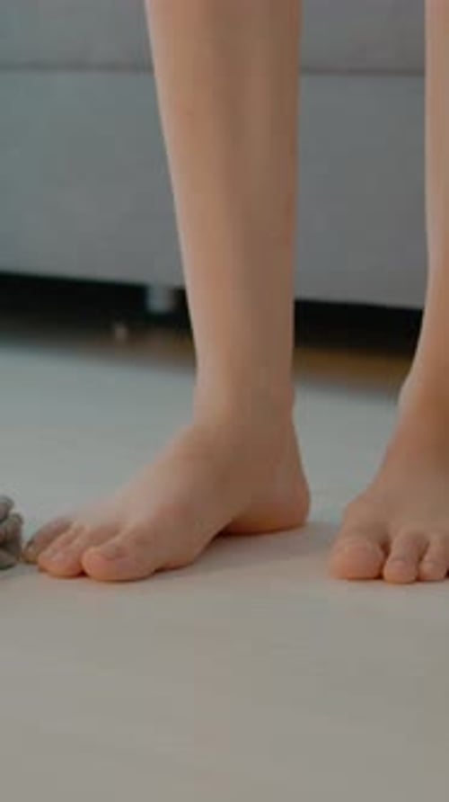 Vertical video Legs shown in home with underwear on the floor and clothing scattered around
