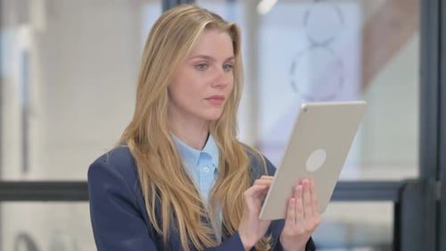 Young Adult Woman Using Tablet in Office