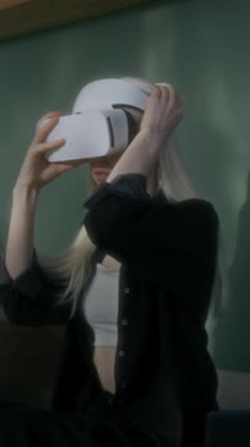 Woman Puts on a VR Headset Indoors