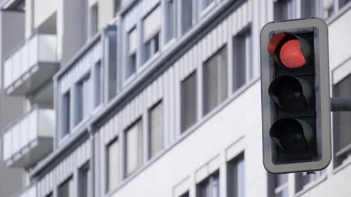 A Red Traffic Light is Sitting in Front of a Building