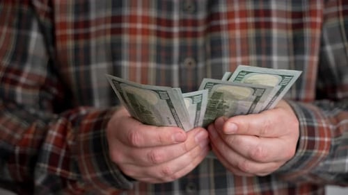 Close-up unrecognizable men's hands count money.